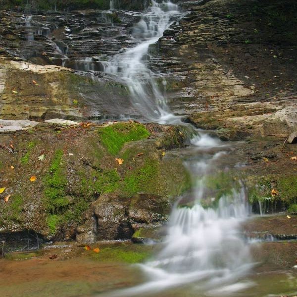 A almost-dry waterfalls zig-zags down irregular rock at Fellows Falls
