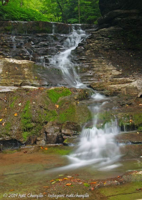 A almost-dry waterfalls zig-zags down irregular rock at Fellows Falls