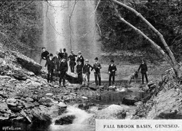 Historic image of some guys in suits at the base of Fall Brook's High Falls in Geneseo