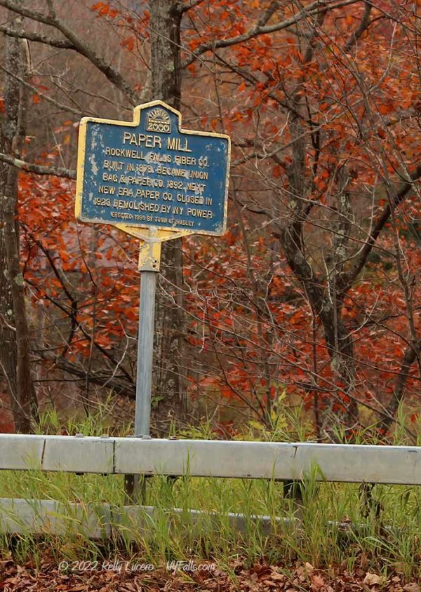 A historic marker for a Paper Mill on the side of the road near Rockwell Falls