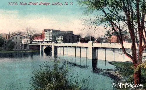 A vintage postcard showing Oatka Creek pond and Main St.