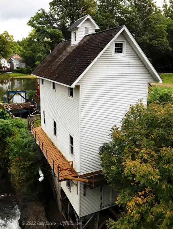 Renovated hydro power facility, a tall white wooden structure with a brown shingled roof