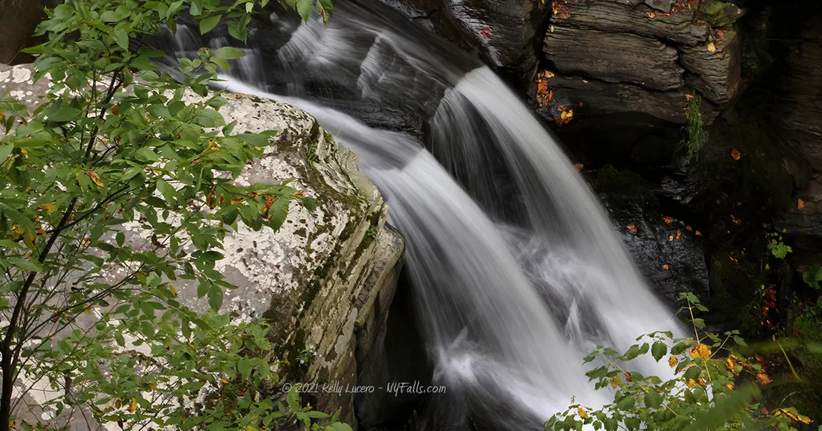 silky water flowing over light and dark rock at Middle Mine Kill Falls