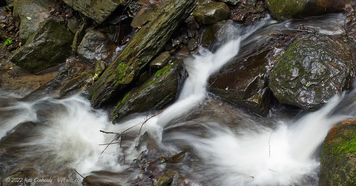 A closeup of water below Bucktail falls bouncing around stones.