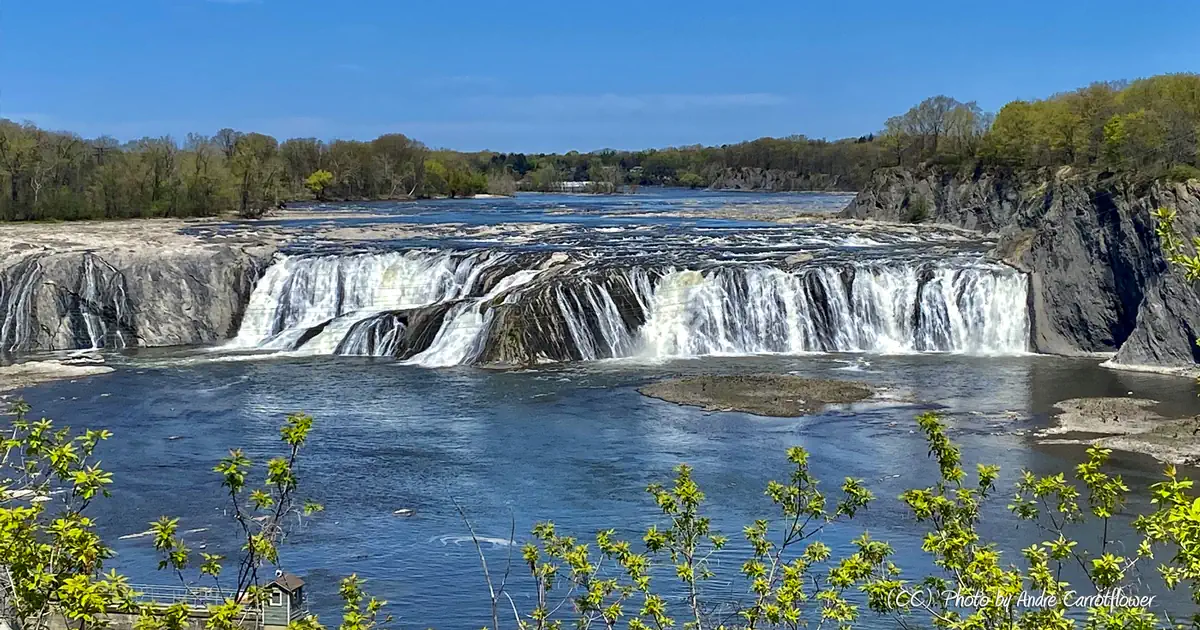 Cohoes Falls under a blue sky. Photo by Andre Carrotflower