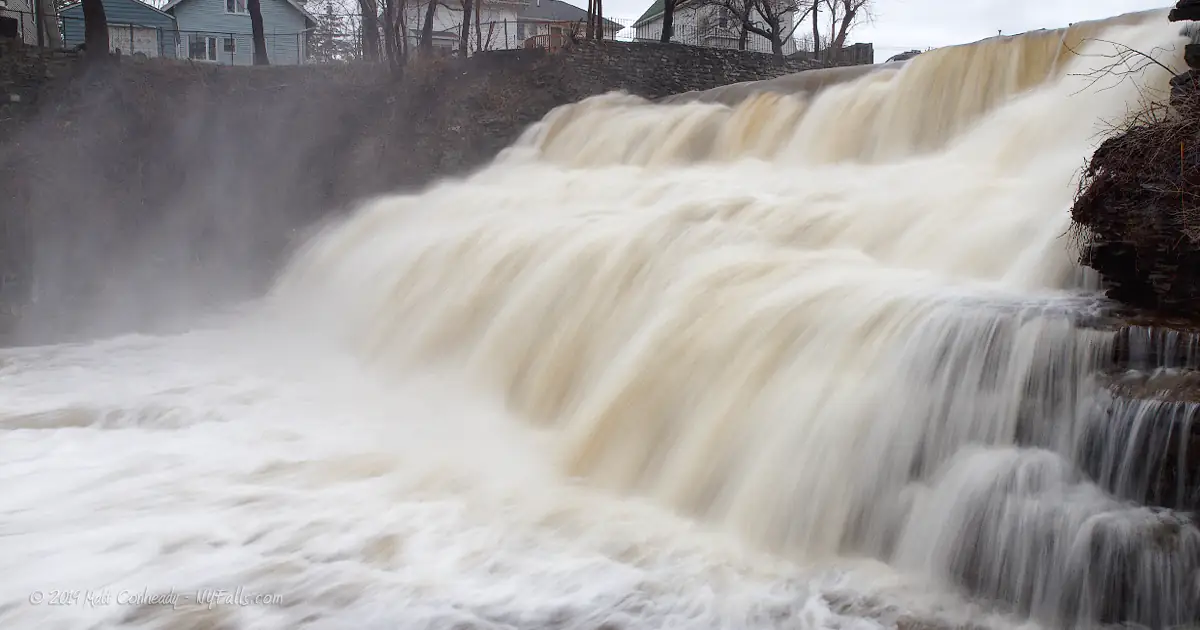 A closeup of Glen Falls in very high, early spring, flow. The water is rushing and a little off-white.