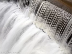 A closeup of the smooth crest of Honeoye Falls, which is a man-made dam, not natural.