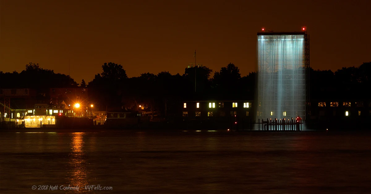 A night view of a man-made waterfall on Governor's Island in New York City.