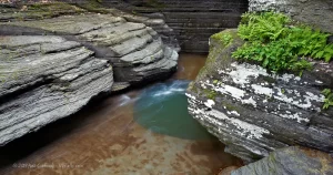 A geological pothole pool in the Buttermilk gorge, surrounded by weathered limestone.