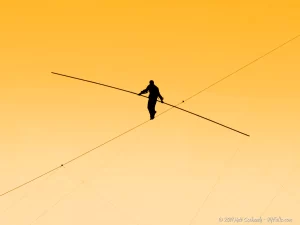 A daredevil (i forgot who) tightrope walks above the Niagara Gorge at sunset.