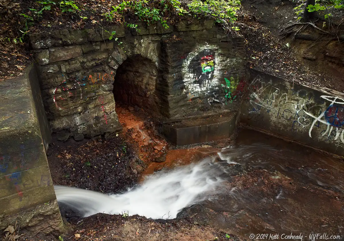 An old stone culvert and tunnel with some light graffiti in Turning Point Park