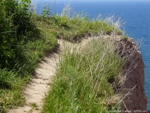 A footpath leads right off a tall cliff.