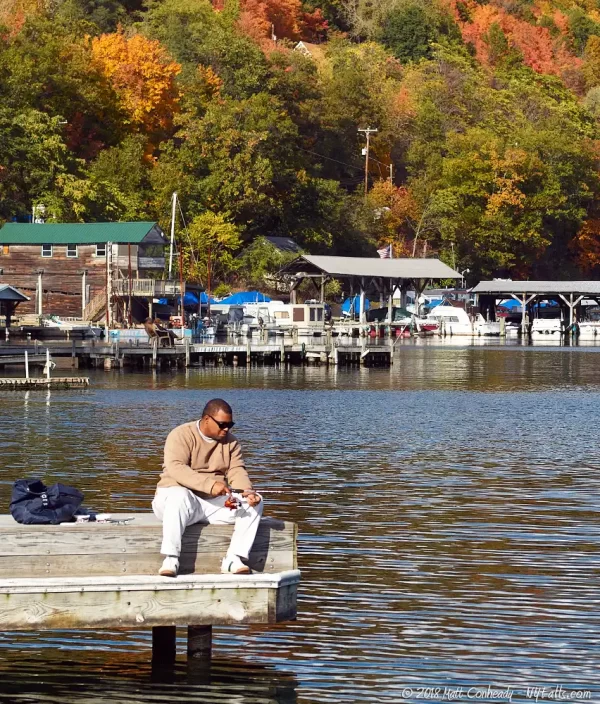 A man fishing from a dock on Keuka Lake in Hammondsport