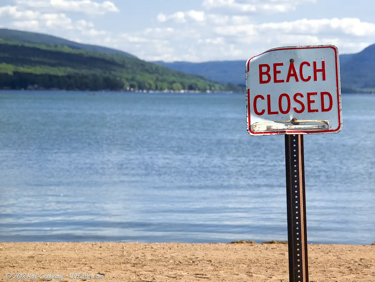 A "beach closed" sign at Sandy Bottom park, during an unusually high pollution season at Honeoye Lake.