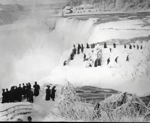 A 1912 photo showing tourists walking on an ice bridge above American Falls.