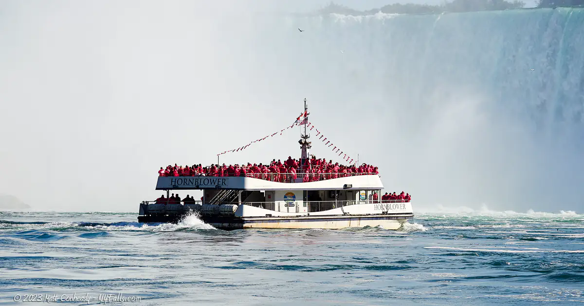 A Maid of the Mist boat with Horseshoe Falls in the Background.