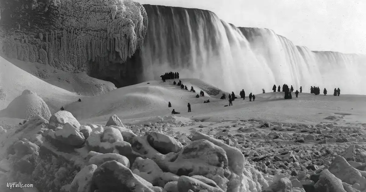 A photo showing tourists on an ice bridge below Niagara Falls in winter.