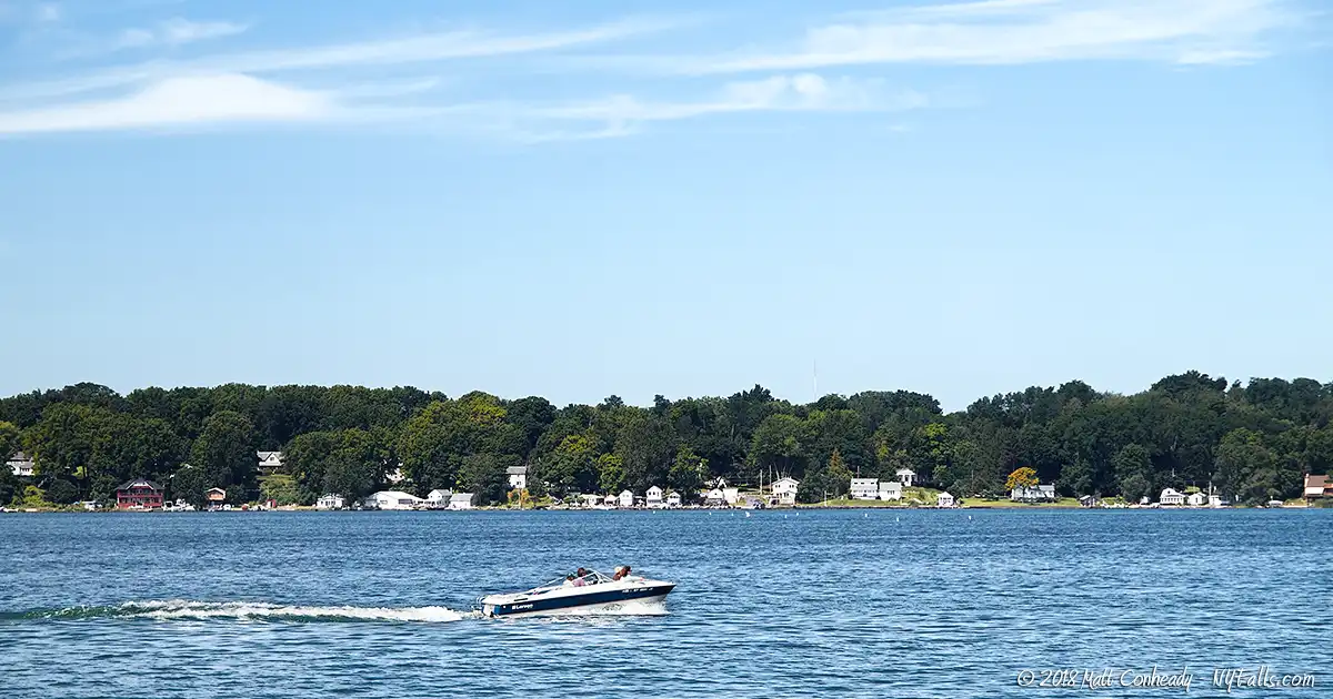 A motorboat speeding across Cayuga Lake