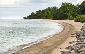 A sandy crescent beach on the east end of Hamlin Beach Park