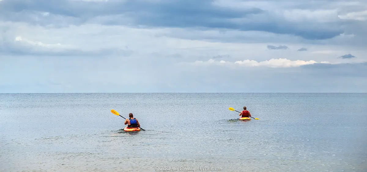 Kayakers Paddling into open waters on Lake Ontario.