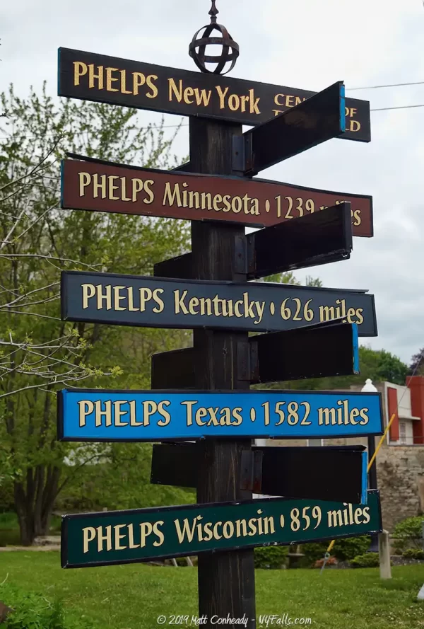 A sign in Phelps New York showing the distances to other places in the US also named Phelps.