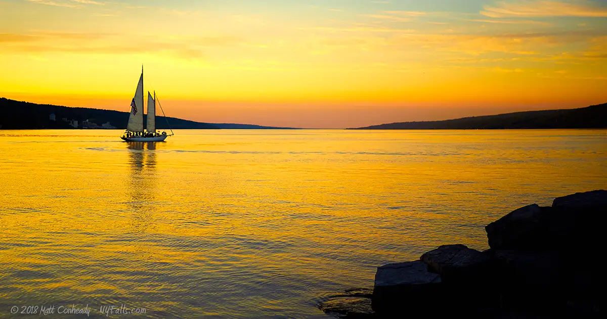 A schooner sailing on Seneca Lake during sunset.