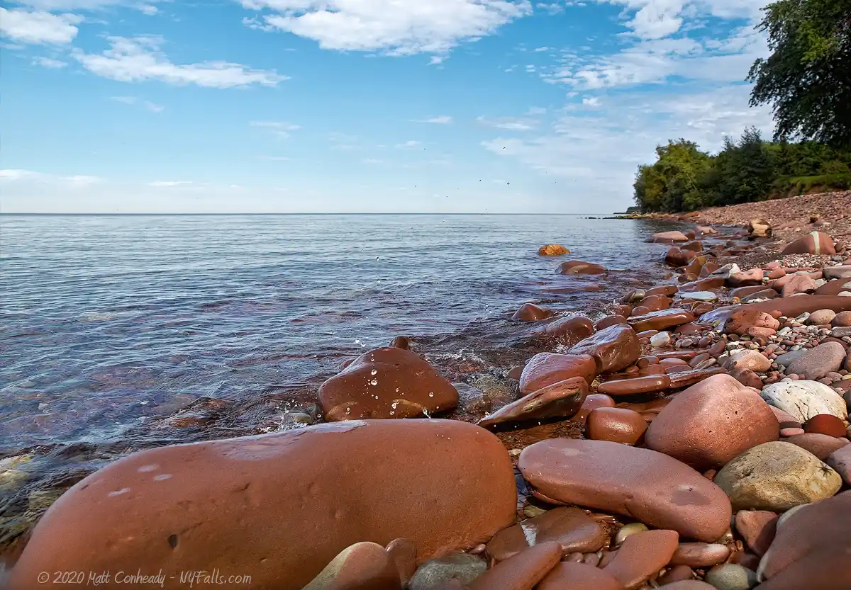 Red sandstone rocky shoreline at B. Forman Park on Lake Ontario.
