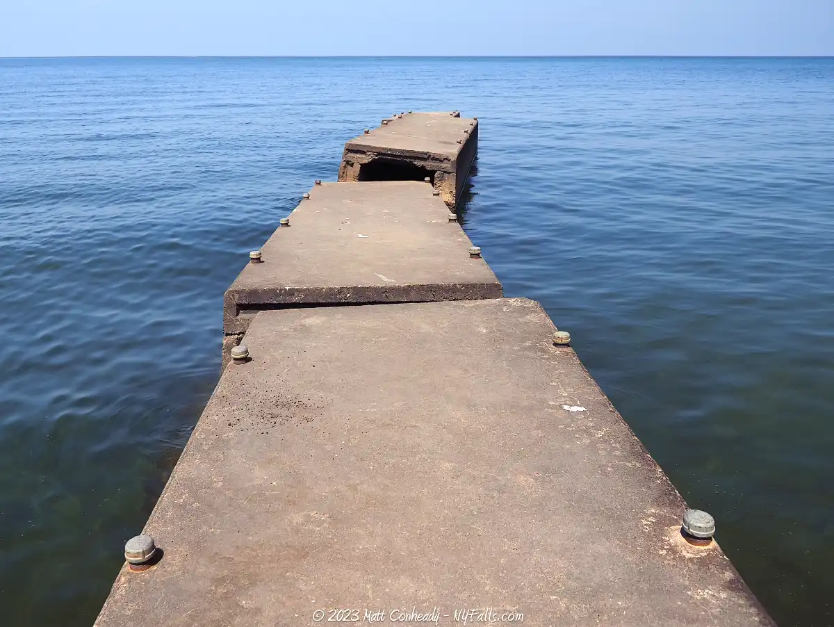 An old concrete pier at Fair Haven Beach is crooked and breaking apart