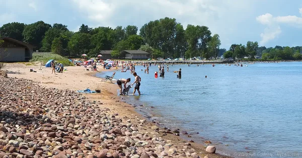 Swimmers along Fair Haven Beach on a summer day.