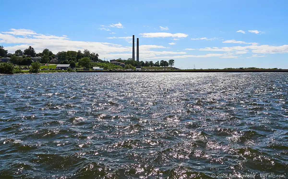 Looking west along the shoreline of Lake Ontario across Breitbeck park toward the Oswego Power Station