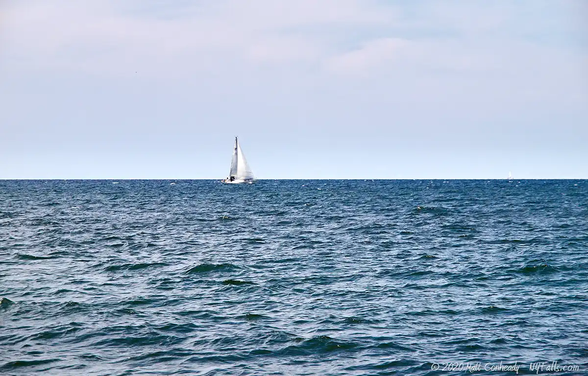 A sailboat on Lake Ontario, seen from Sandbar Park in Webster, NY