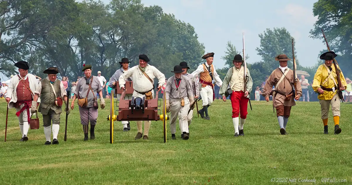 Soldiers marching with a canon at Fort Ontario in Oswego, NY.