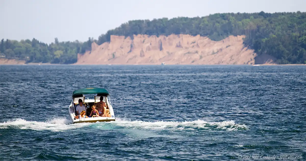 A family takes their boat towards the Chimney Bluffs after launching it at Sodus Point