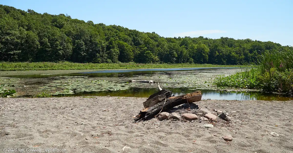 A view of Beaver Creek Marsh at Beachwood Park. In the foreground is an old campfire on a sandbar.
