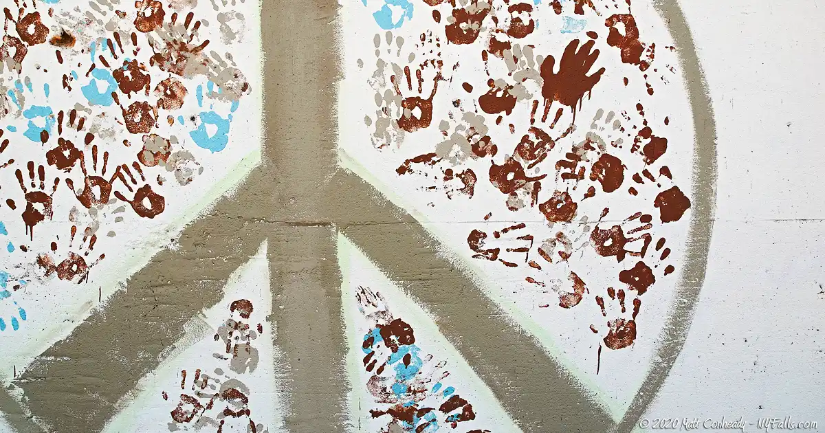 Wall art on the Lake Erie Seaway Trail Visitor Center showing a peace sign and hand prints of all sizes and colors