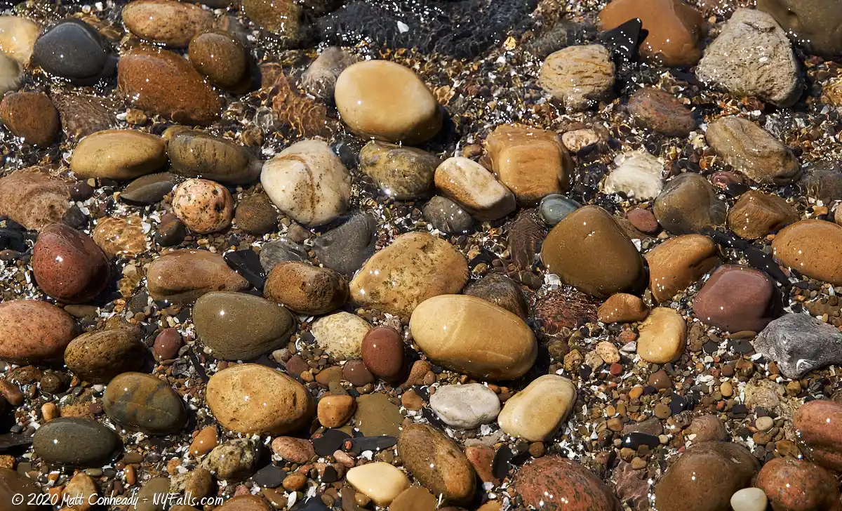 A close up of the orange-tinted pebbles that make up Wendt Beach