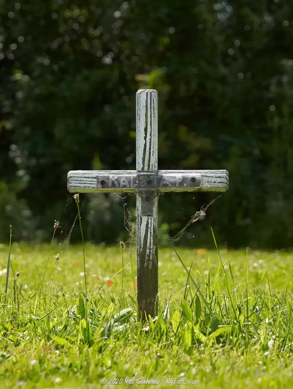 A cross-shaped wooden grave marker at Saint Hyacinth Cemetery in Dunkirk, NY