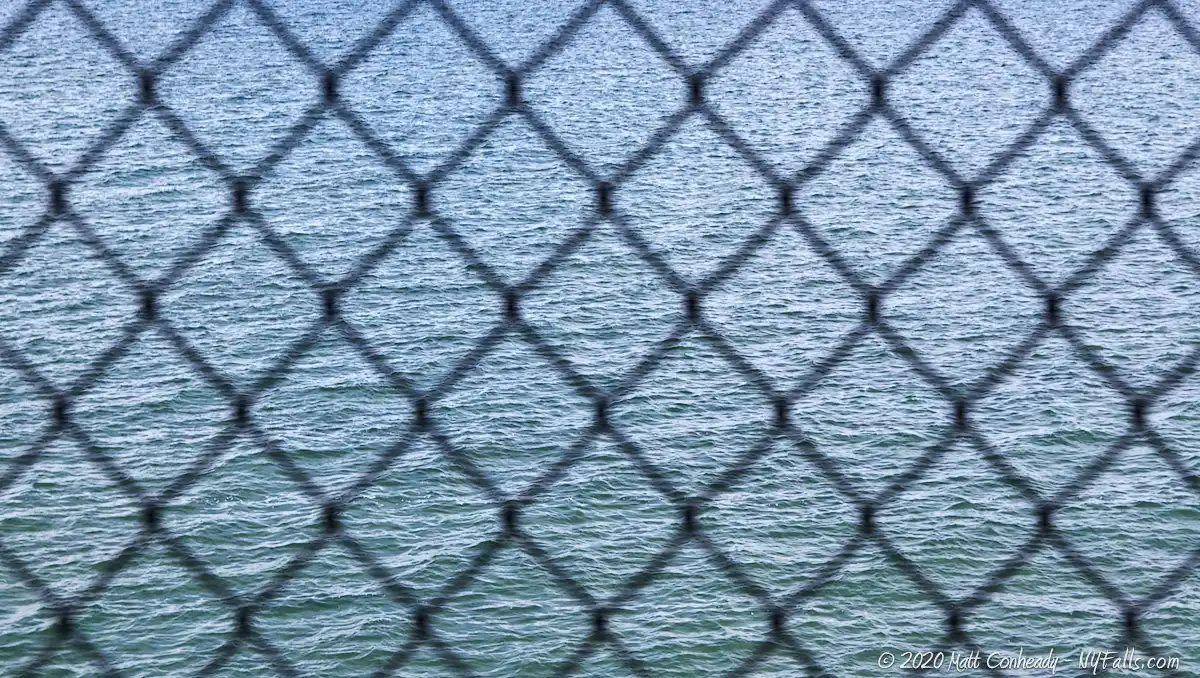 A view through a chain-link fence at Lake Erie