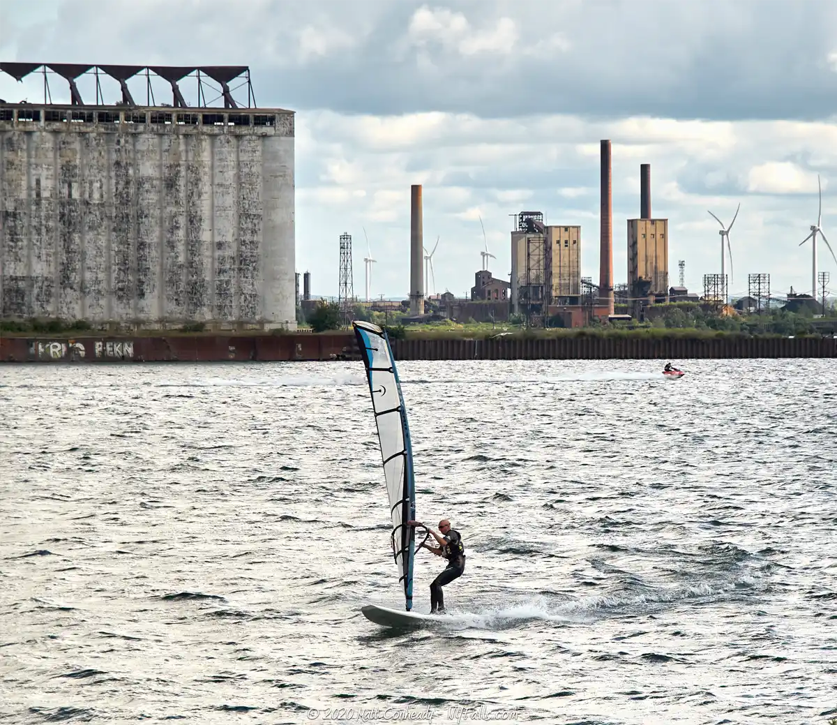 A sailboarder riding on Lake Erie just off Gallagher Beach