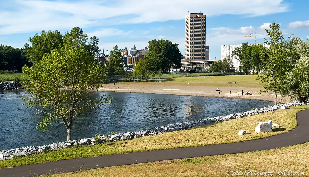 A walking path, slip and beach at Wilkeson Pointe Park, with downtown Buffalo in the background.
