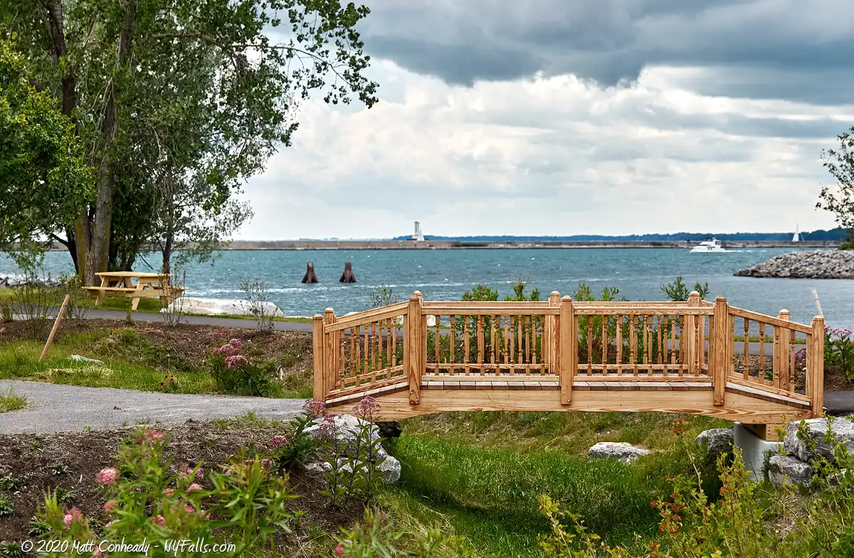 A bridge and picnic table in Wilkeson Pointe Park that have great views of Lake Erie and the outer harbor.