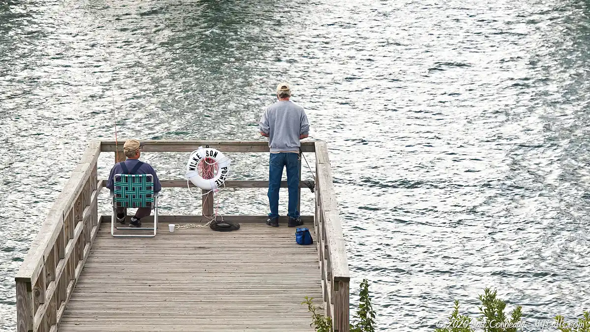 Two men fishing off a platform at Wilkeson Pointe