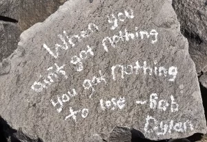 A quote from Bob Dylan written on a stone on the Cattaraugus Creek Harbor breakwall. It says "When you ain't got nothing, you got nothing to lose"
