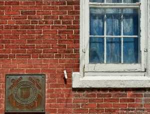 the brick exterior of the Dunkirk Lighthouse with plaque for the US Coast Guard.