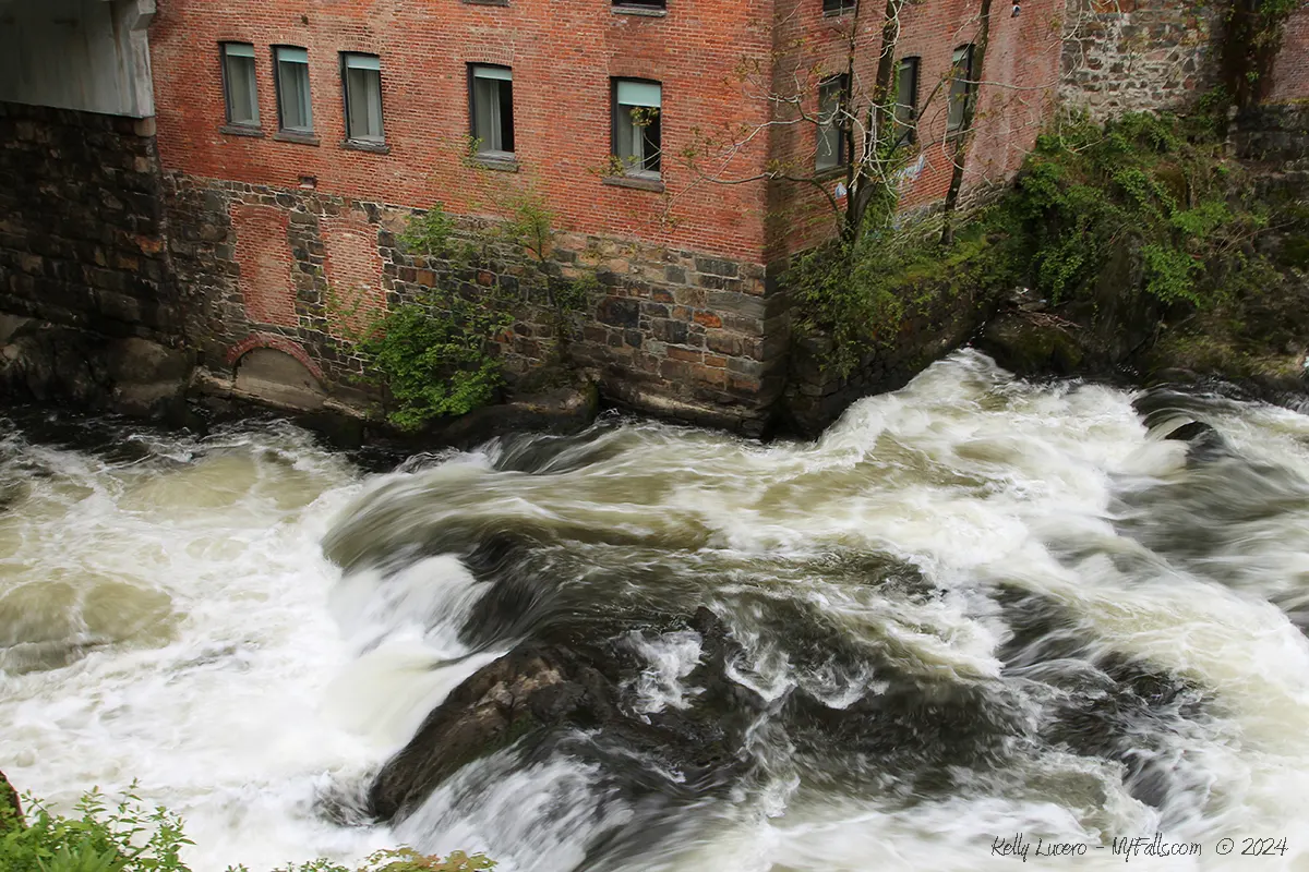 Rushing water of the Fishkill Overlook Falls makes contact with the Roundhouse Hotel just before it passes under the bridge. Beacon, NY