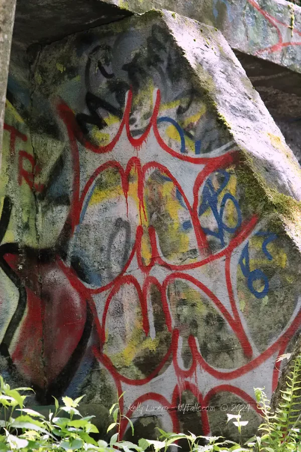 Graffiti painted in red blue and yellow, on a wall at Zabriskie's Waterfall