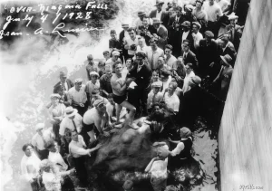Jean Lussier and a crowd of press after he went over niagara falls in a rubber ball