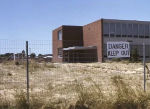 Abandoned 99th Street Elementary School with large 'Danger, Keep Out' sign on it